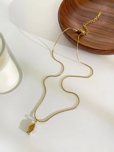 Detail of gold fish pendant necklace featuring adjustable chain and lobster clasp