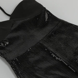 Detail of black sequined evening dress showing fabric texture and stitching quality