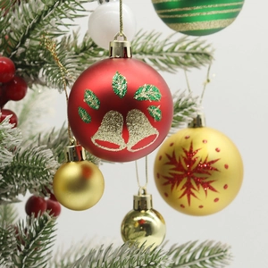 Set of 16 multicolor Christmas ball ornaments with festive patterns on a snowy tree