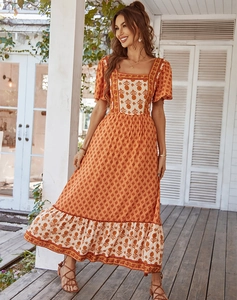 Detailed close-up of Bohemian floral print on a square-neck maxi dress with ruffled sleeves