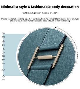 Close-up of pebble grain leather texture and gold metal buckle on a teal backpack