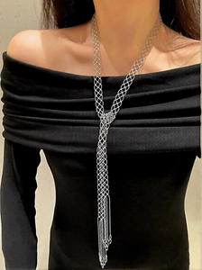 Elegant silver mesh bowknot tassel necklace shown on a model with black dress