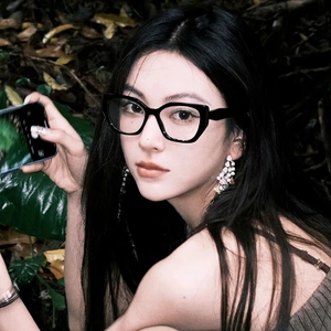 Detailed view of square black frame glasses and long rhinestone tassel earrings on a model