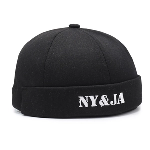 Retro black cotton skullcap with white NY&JA letter embroidery in a minimalist style