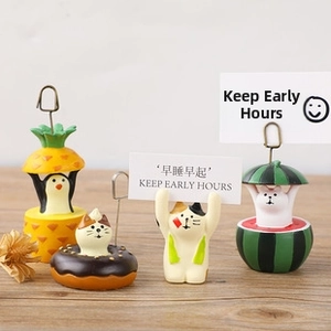 Set of four cute animal desk memo holders including penguin and cat shapes on wood