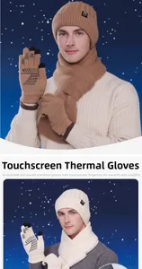 Close-up of touchscreen-compatible knit gloves and warm winter hat set in beige