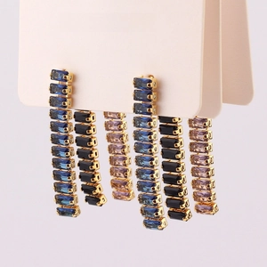 Detail of elegant rectangular crystal drop earrings in blue and purple on a display card