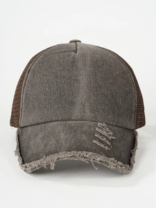 Close-up of distressed washed grey trucker hat showing vintage mesh and worn edge details