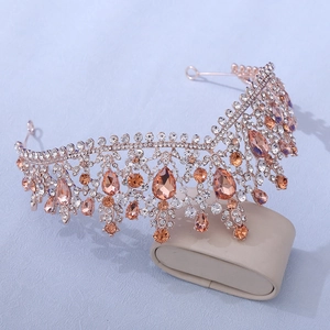 Detailed close-up of rose gold bridal crown with peach and clear teardrop crystals