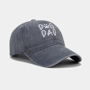 Detail of Dog Dad embroidery on a washed charcoal grey cotton baseball cap with paw print