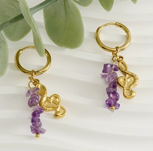 Detail of 18k gold musical note earrings with natural purple amethyst stone chips