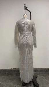 Detailed back view of silver sequin evening gown showing fish-tail hem and long sleeves