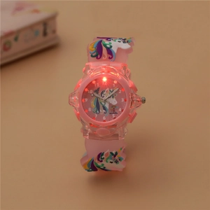 Close-up of pink unicorn kids watch with glowing LED light and soft silicone strap
