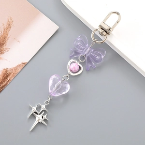 Detail of purple acrylic bow and heart beads on y2k style star keychain accessory