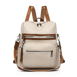 Minimalist beige and brown faux leather backpack with multiple zipper pockets and top handle