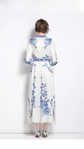 Detail of white long sleeve maxi dress with blue floral print and matching belt