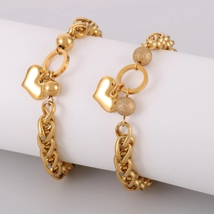 Golden chunky chain bracelet featuring a heart pendant and dual-texture spherical charms