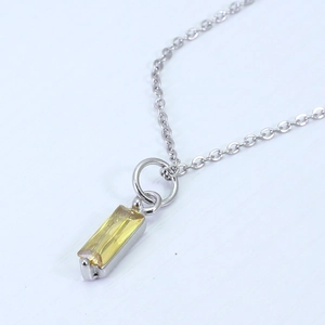 Macro shot of rectangular yellow zircon pendant set in silver on a fine silver necklace
