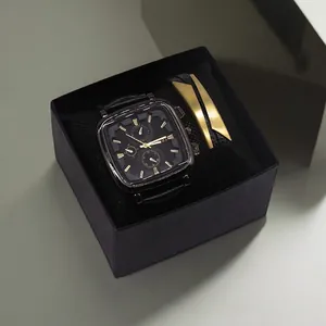 Close-up of men's square black watch and leather bracelet set in a gift box