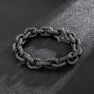 Detail of vintage men's steel chain bracelet with a hammered texture and dark silver finish
