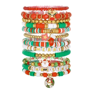 Detailed view of handmade Christmas bracelets with red and green beads and festive charms