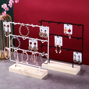 Three-tier metal jewelry display stand with wooden base for earrings and necklaces