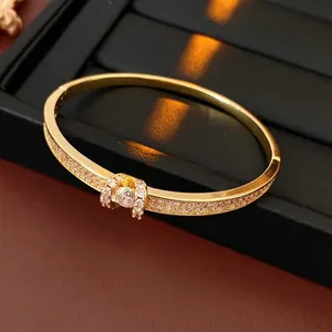 Luxurious gold-plated oval bangle featuring micro-paved cubic zirconia and a buckle design