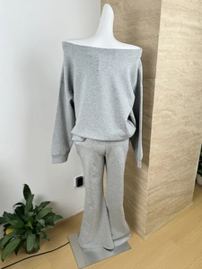 Detail of grey knitted cotton loungewear set showing off-shoulder top and wide-leg trousers