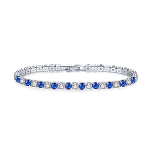 Detailed close-up of sapphire and cubic zirconia tennis bracelet with silver plating
