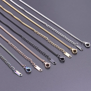 Flat lay of 2.2mm flat link necklaces in silver, gold, rose gold, black and rainbow finishes