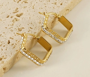 Detail of 18K gold plated square earrings with rhinestones and Greek fret pattern