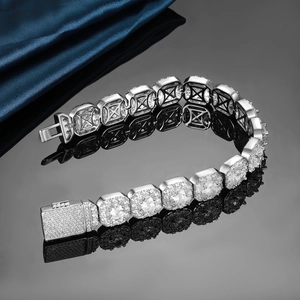 Detail of 12mm silver cuban link tennis bracelet with zircons on reflective surface