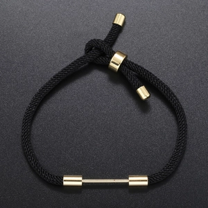 Adjustable black woven rope bracelet with gold metal accents and sliding closure design