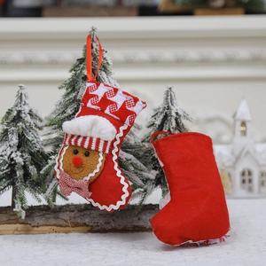 Mini Christmas stocking with gingerbread man decor and red checkered cuff hanging on tree