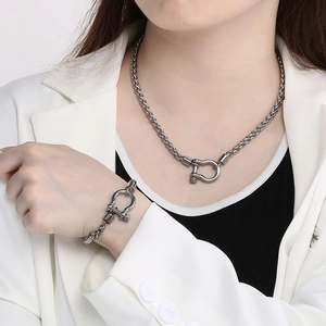 Silver stainless steel horseshoe buckle chain necklace and bracelet set on a model