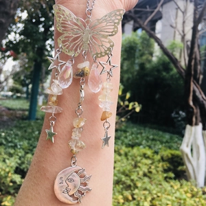 Detailed suncatcher with silver butterfly, yellow crystals, and sun moon charms