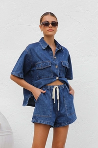 Detail of vintage blue denim set with short sleeve button shirt and drawstring shorts