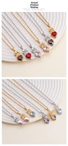 Detail of heart-shaped crystal pendant with crown motif and zircon inlay on gold chain