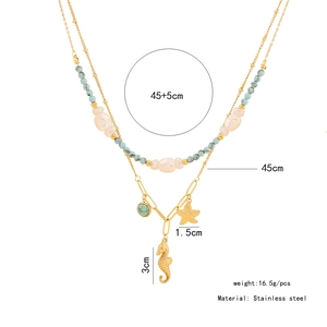 Detail of stainless steel layered necklace with turquoise beads and seahorse pendant