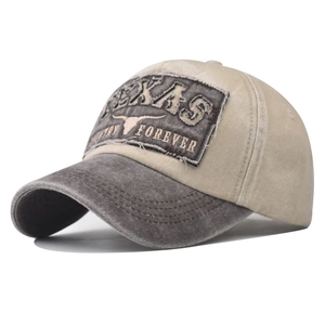 Detail of Texas Forever bull embroidery on a washed vintage khaki and gray baseball cap