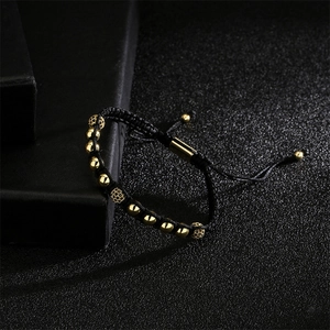 Detail of adjustable woven bracelet with 18K gold beads and black micro-pave zircon spheres