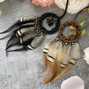 Retro dream catcher car charm with natural stones and feathers on grey texture