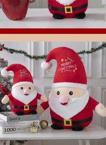 Detail of two plush Santa Claus dolls in different sizes with Merry Christmas embroidery