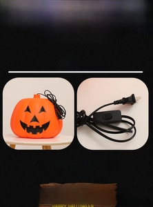 Detail showing dual power options of orange pumpkin lamp with battery case and power plug