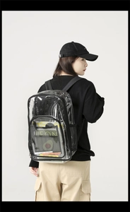 Side view of large transparent waterproof PVC backpack worn by model in casual setting