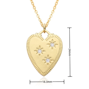 Macro shot of 24mm gold heart pendant with frosted finish and star-set cubic zirconia