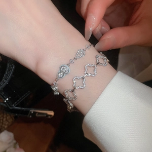 Detail of 18k gold plated bracelet featuring zircons, pearls and gourd-shaped charms
