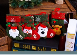 Close-up of four vintage Christmas stockings featuring Santa, snowman, bear and reindeer