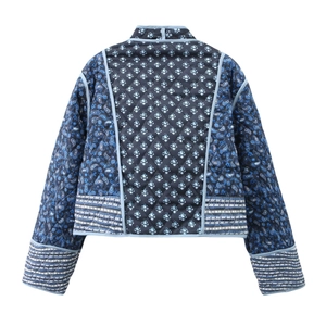 Detail view of the quilted reversible jacket with blue floral and paisley patterns