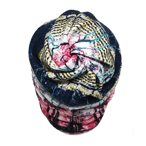 Close-up of lightweight beanie with blue, yellow and pink abstract floral patterns